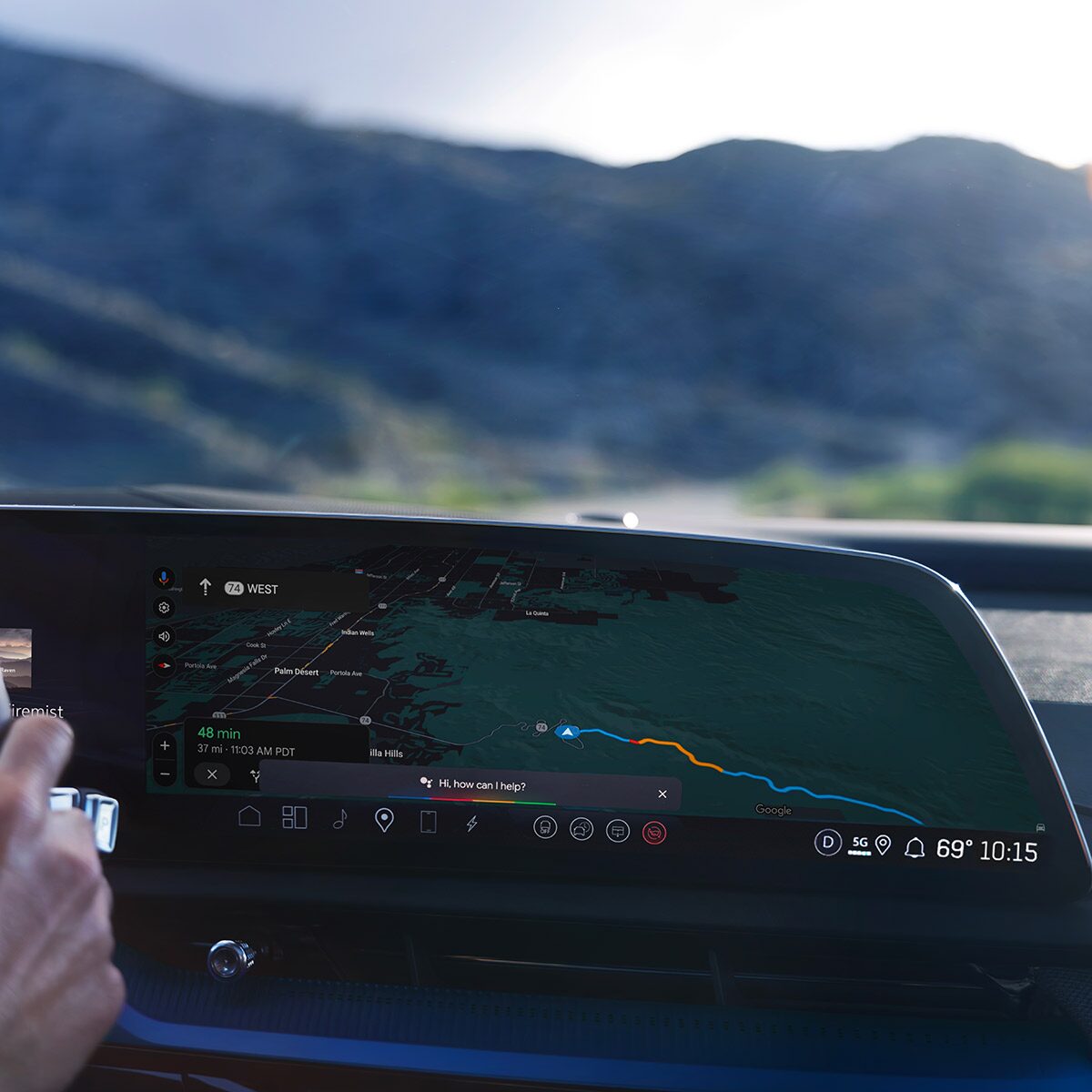 Close-up of Someone Driving the 2026 OPTIQ-V and Utilizing the Navigation on the Display Screen