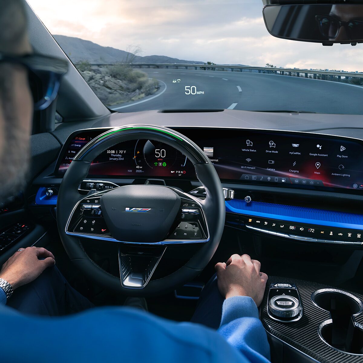 Driver Seat View of a Man Driving the 2026 OPTIQ-V Down the Road While Using the Hands-Free Super Cruise Feature