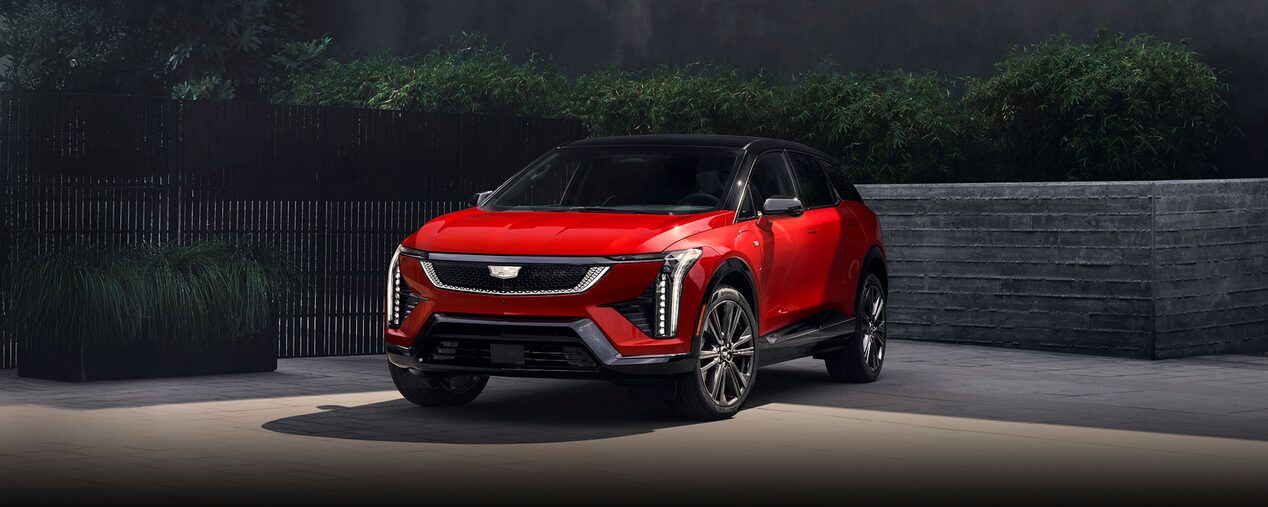 A Red 2026 Cadillac OPTIQ Parked in a Driveway