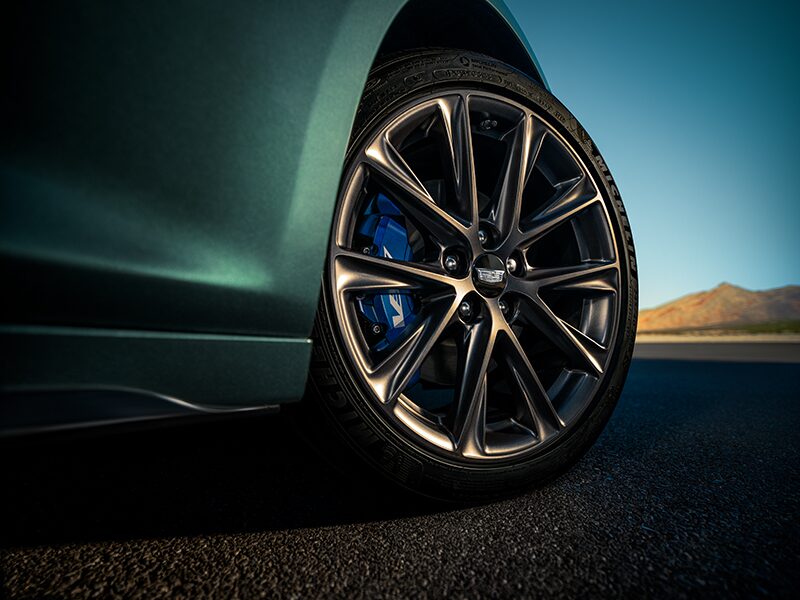 Low Angle View of a Front Tire Of a  Cadillac CT5-V Driving Down the Road
