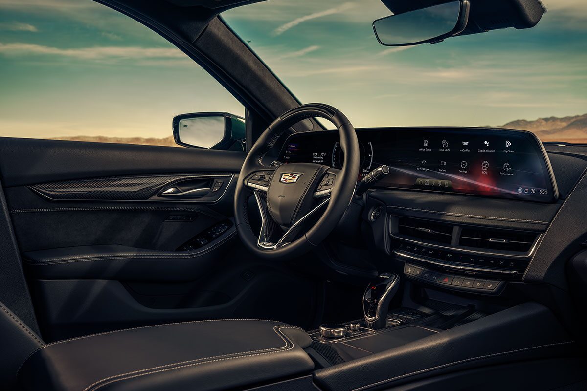 Front Passenger View of the 2025 Cadillac CT5-V Interior Steering Wheel and Dashboard Under a Beautiful Sky