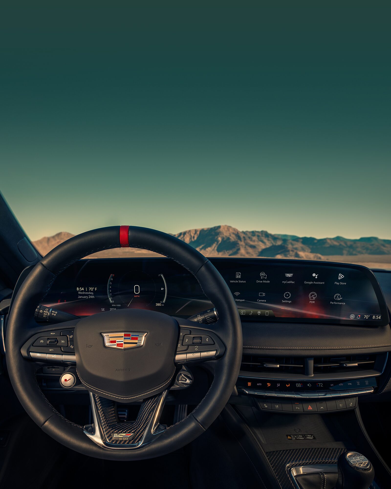 Driver's Seat View of a Cadillac CT5-V Steering Wheel and Driver Information Center Outlooking the Mountains