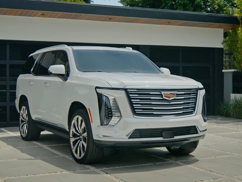 Three-Quarter View of a White 2026 Escalade Parked in Driveway