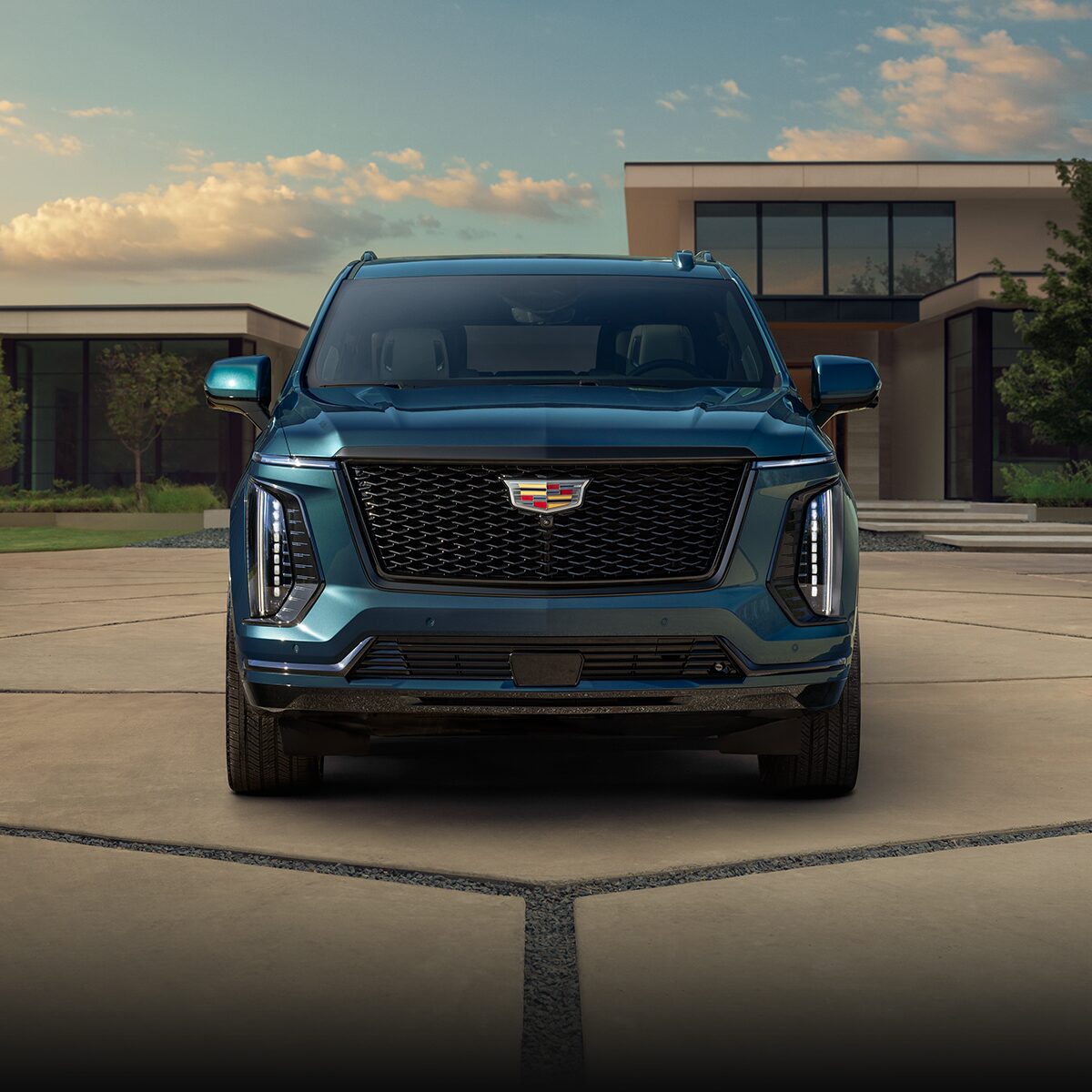 Front View of a Blue 2026 Cadillac Escalade Grille Parked in Driveway