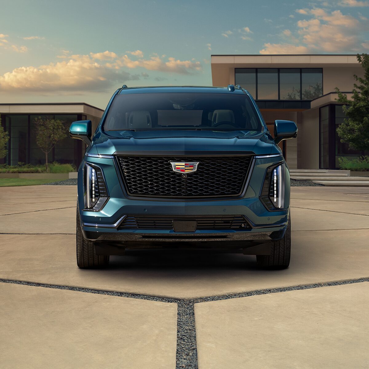 Front View of a Blue 2026 Cadillac Escalade Grille Parked in Driveway