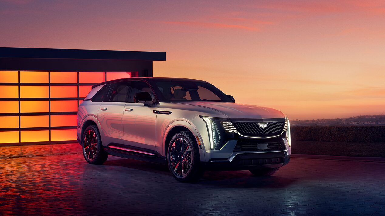 Front Profile of the 2025 Cadillac ESCALADE IQ Parked Outside of Modern Building