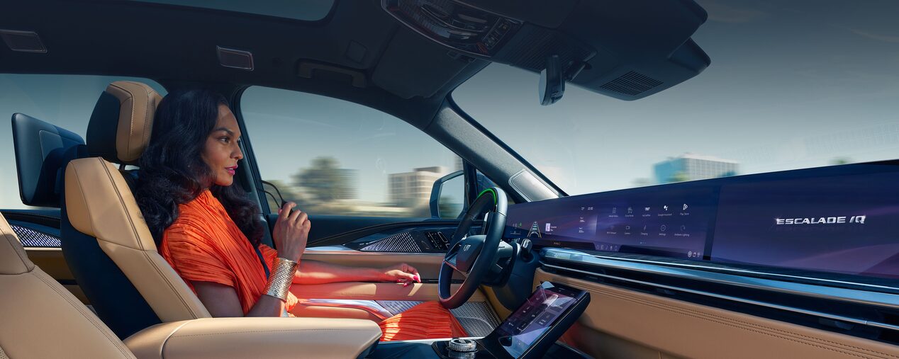 Woman Smiling While Driving the 2025 Cadillac ESCALADE IQ Using SuperCruise