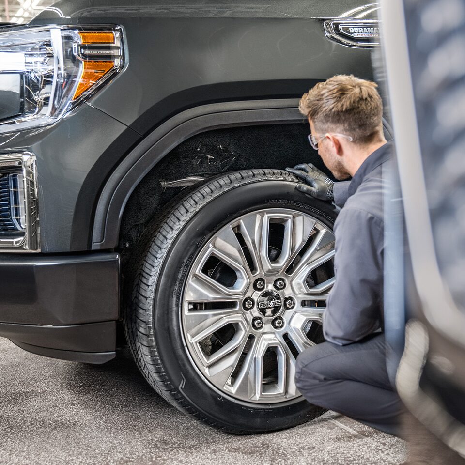 Close-up of a Mechanic Working on a GMC Truck
