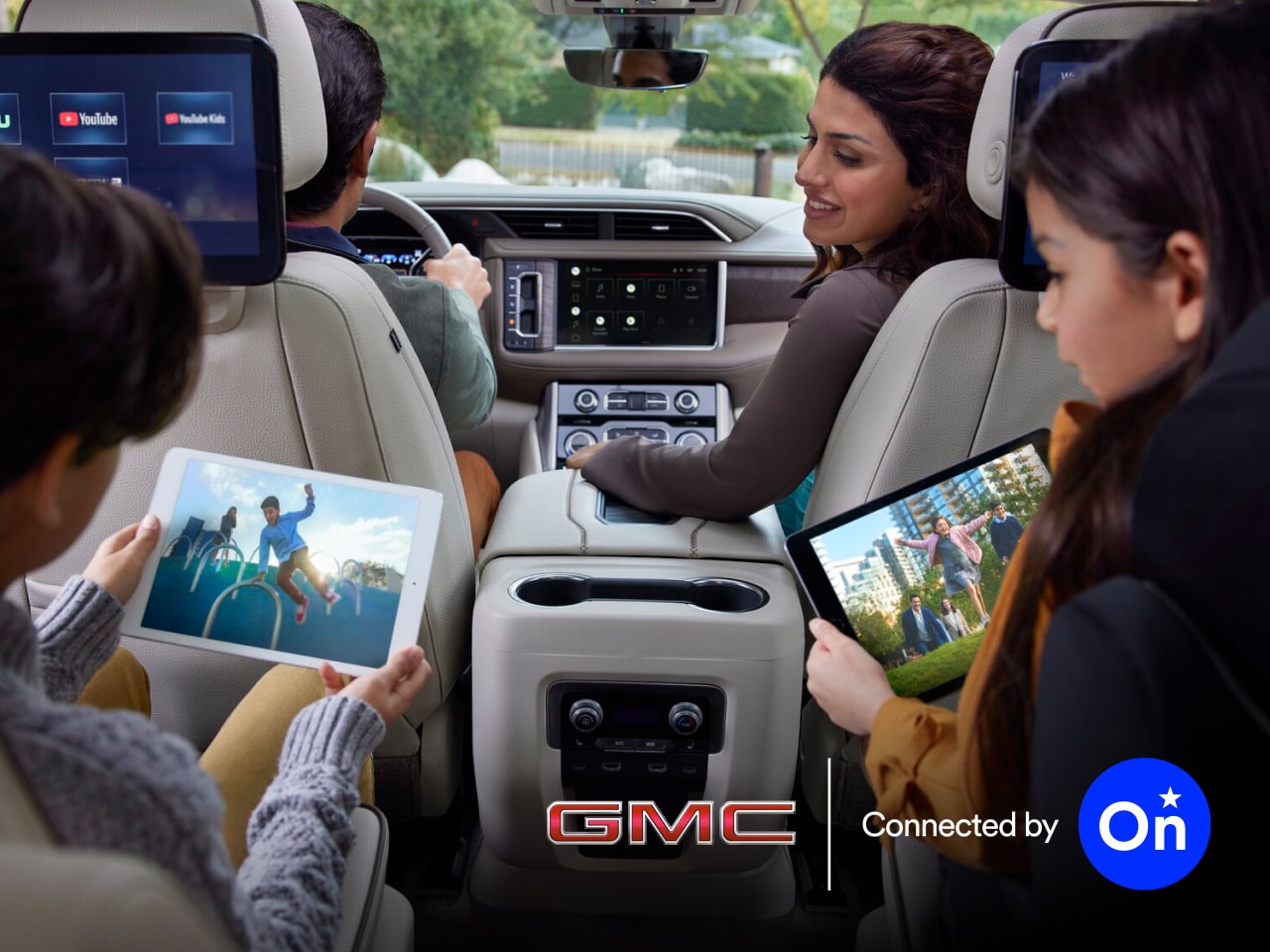A Family of Four Embarking on a Road Trip in Their GMC Vehicle