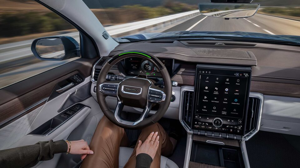 Overhead View of a Woman Using the Super Cruise Hands-Free Technology in Her GMC with Her Hands Placed on Her Lap