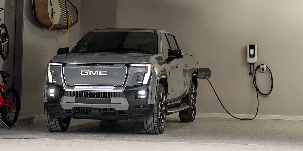 Close-up of a GMC EV Plugged in to an at Home Charging Station