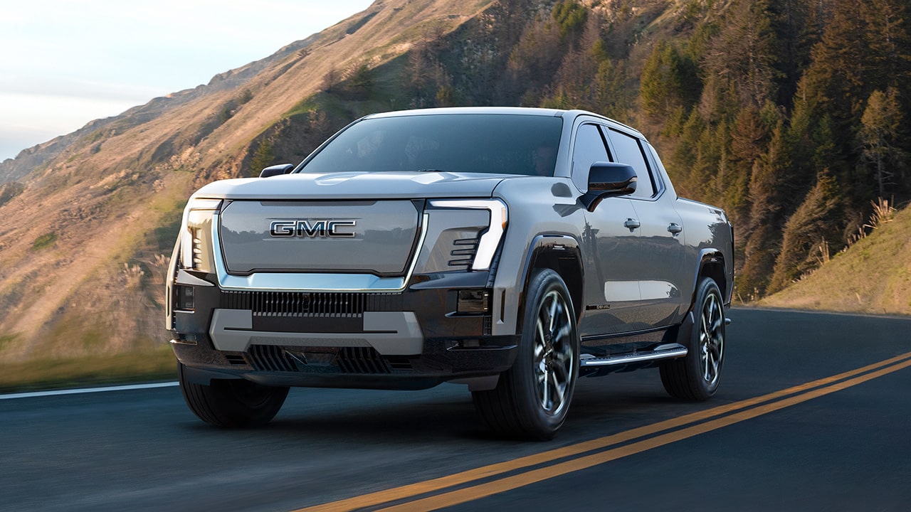 The GMC Sierra EV Driving Down a Winding Mountain Road Along the Coast