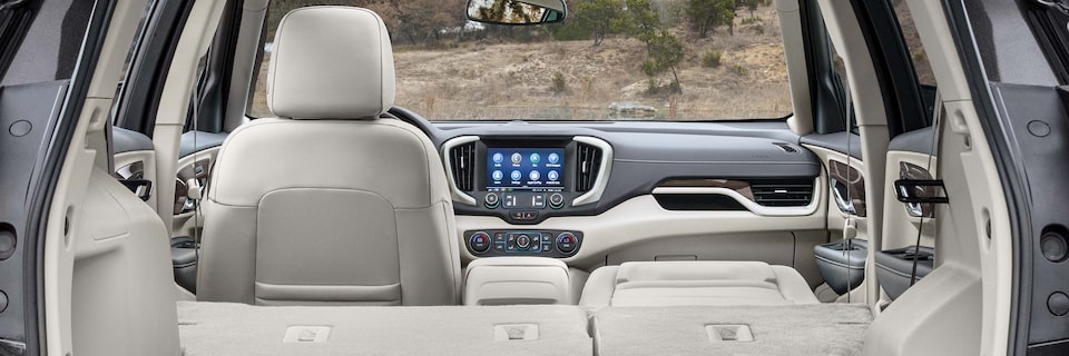 View of the Interior of GMC SUV Through the Rear Open Tailgate with the Rear Seats Placed Down