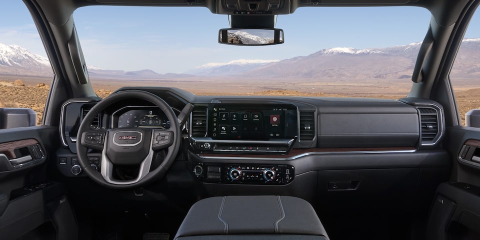 Interior View of the GMC Truck Dashboard with a Mountain View Through the Windshield