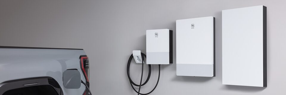 Close up of the Sierra EV plugged into a home charging station.