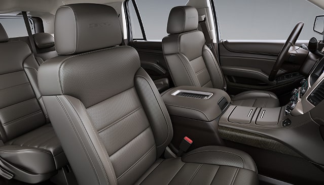 The Brown Leather Interior of a GMC Yukon Denali With Perforated Seats and a Center Console