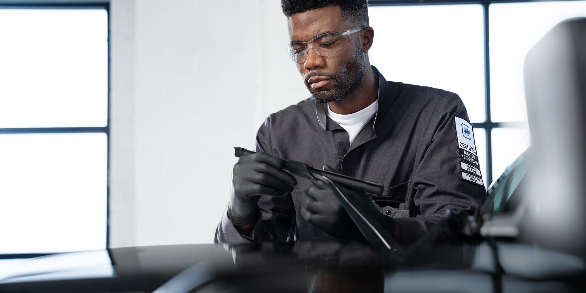 GMC Certified Service Technician Inspecting a Windshield Wiper