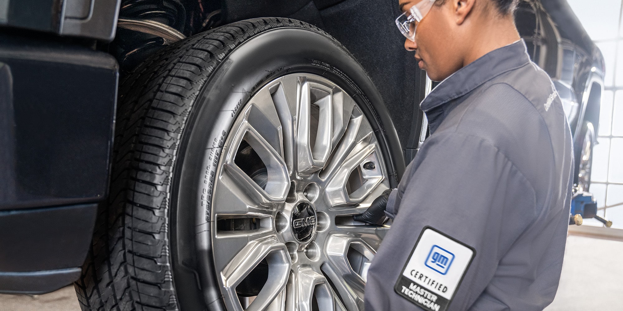 A Mechanic Observing the Tire of a GM Vehicle