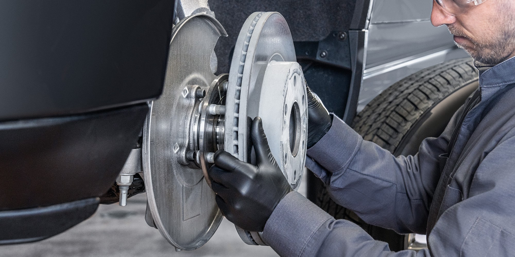 A Mechanic Is Replacing the Air Filter of a Vehicle