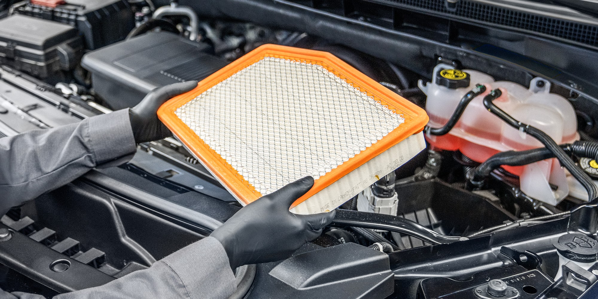 A Mechanic Wearing Safety Glasses Inspecting the Break of a Wheel inside a Vehicle