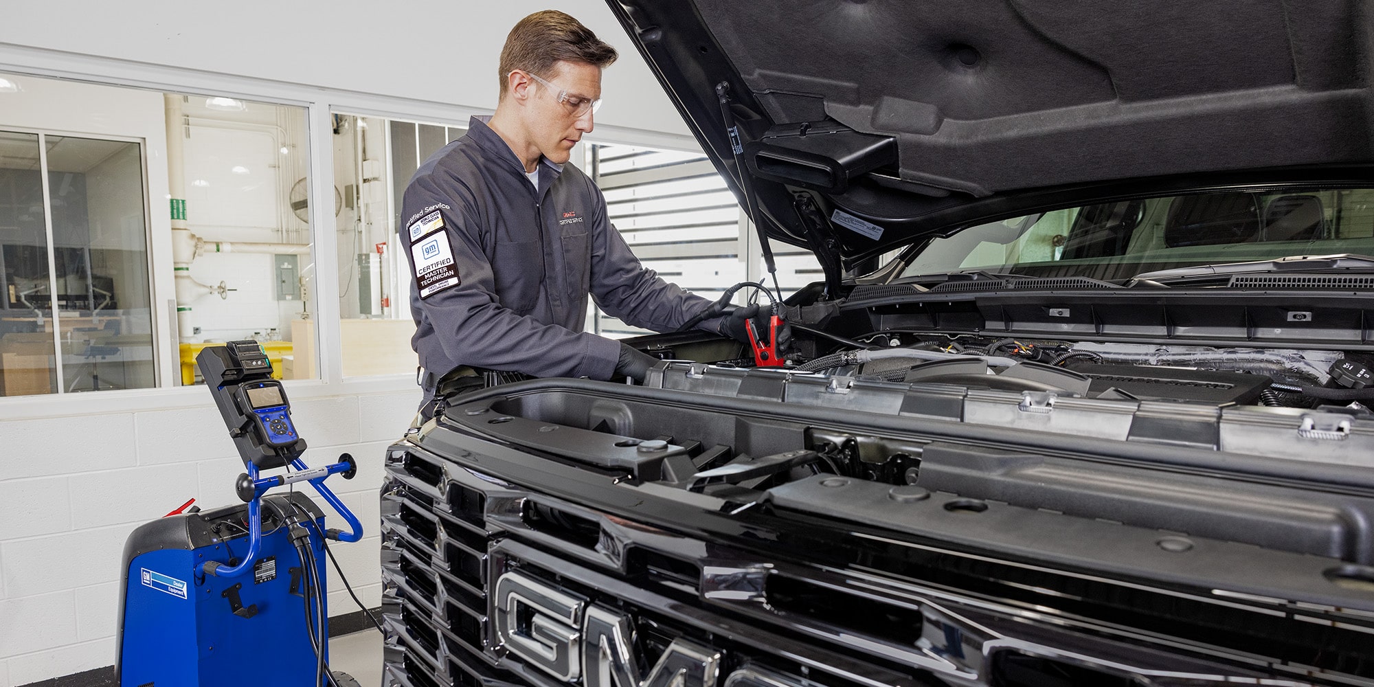 GMC Certified Service Technician Inspecting a Vehicle