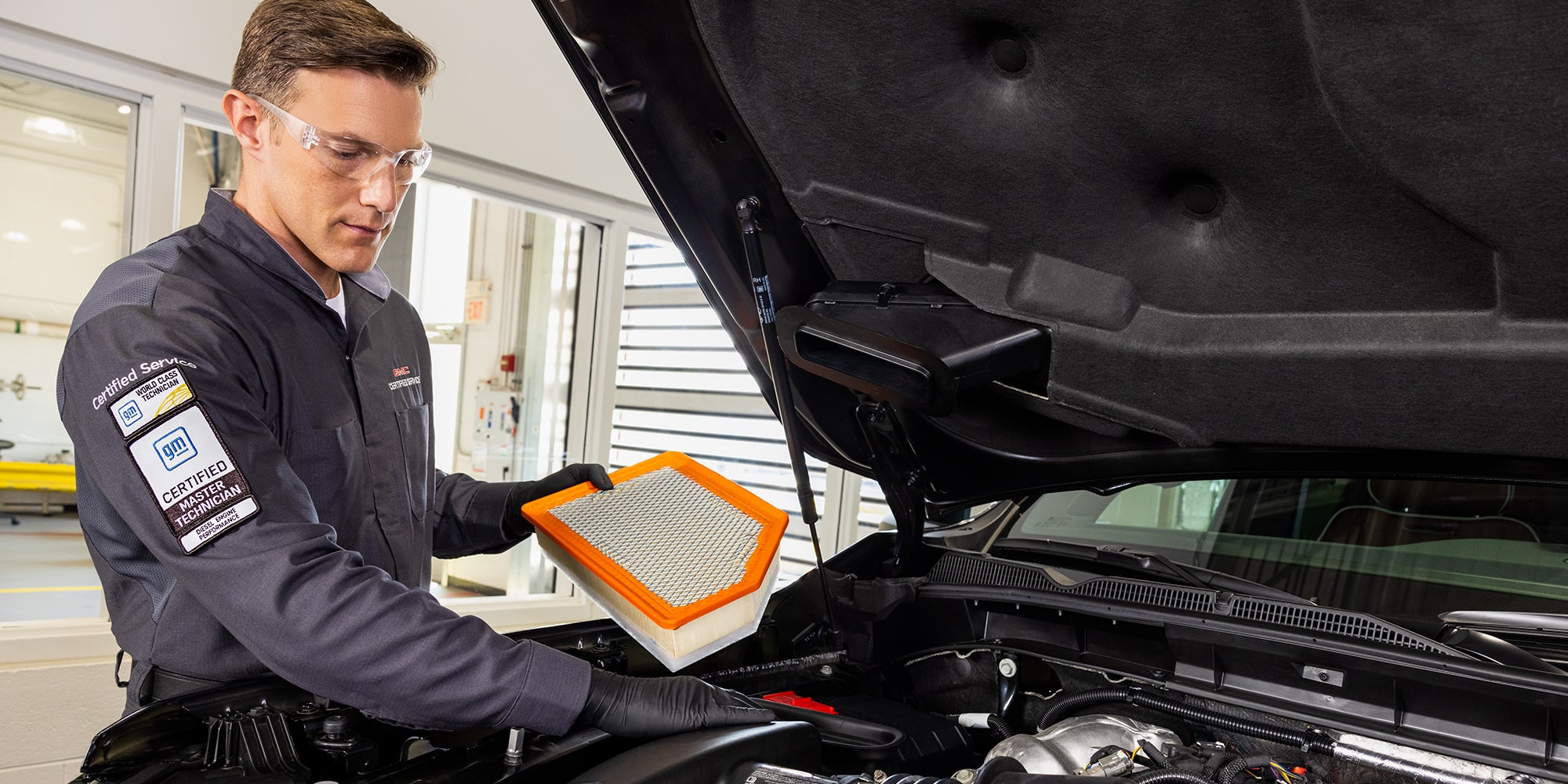 GMC Certified Service Technician Installing a Cabin Filter in a Vehicle