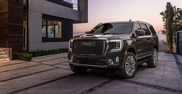 Black GMC SUV Parked Outside House