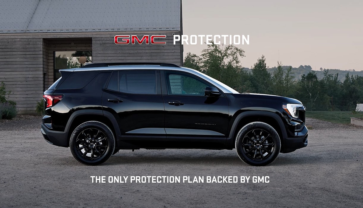 GMC Truck Driving Along a Cliffside Road