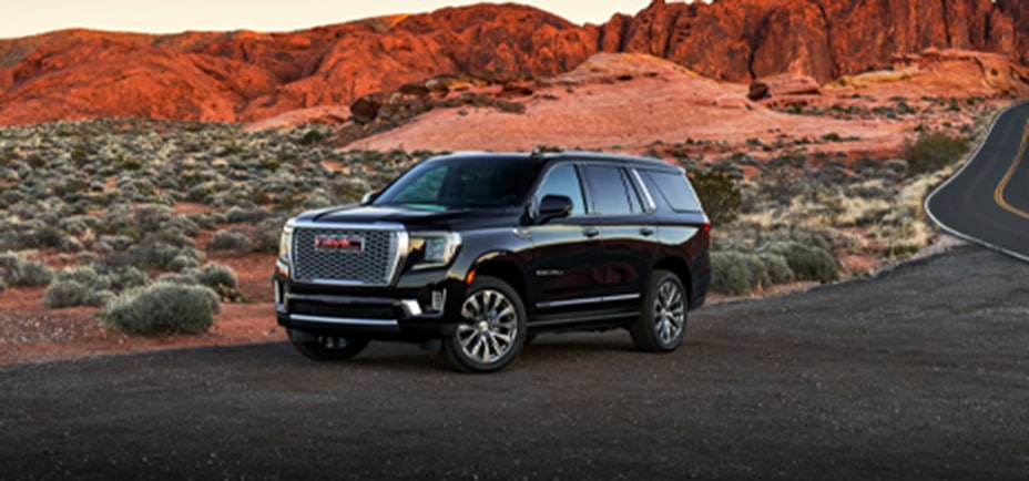 A Black GMC SUV Parked on the Side of a Desert Road