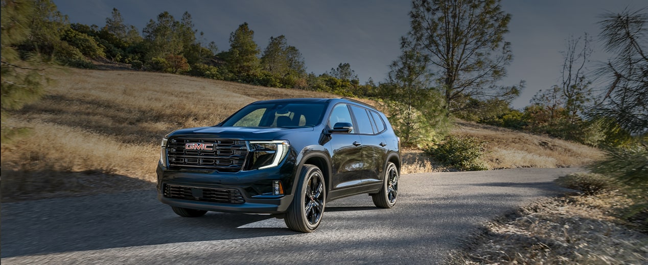 A Black GMC SUV Driving on Rural Road