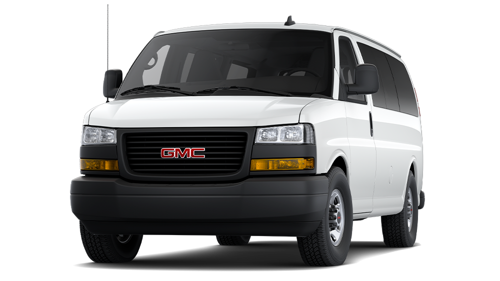 Front View of a White 2026 GMC Savana Passenger Van Against a Black Background