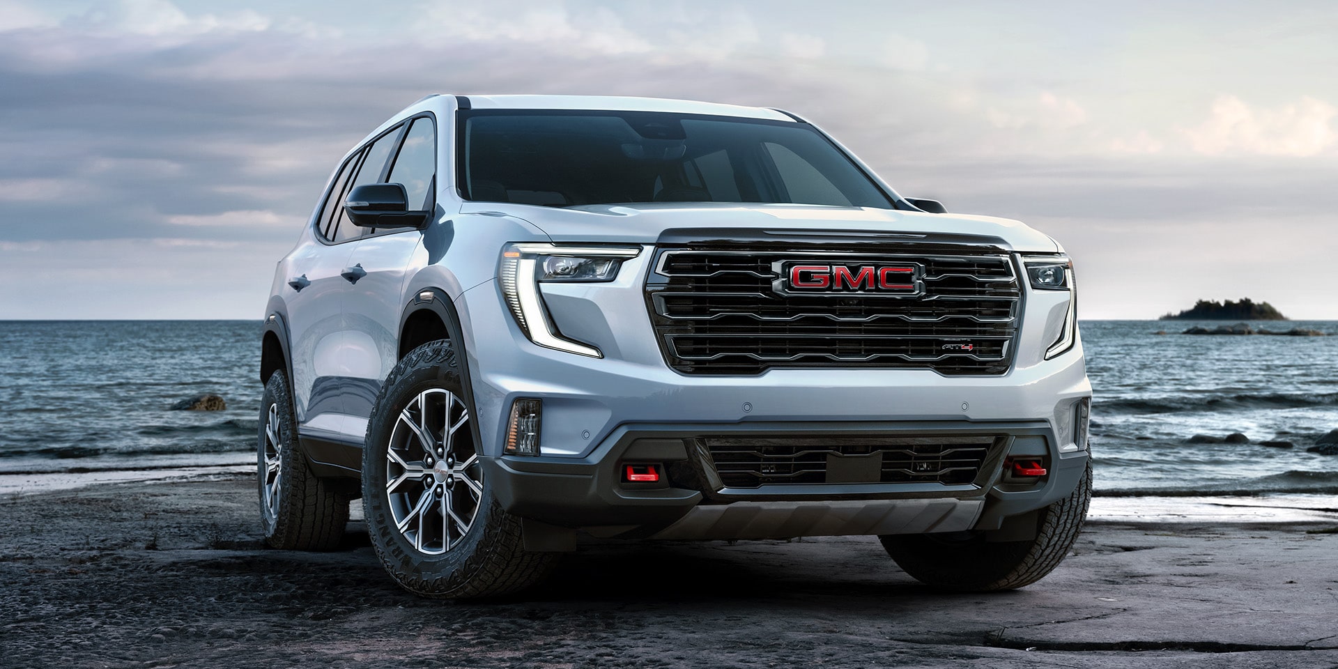 Front Three-Quarters View of the GMC Acadia AT4 Mid-Size Off-Road SUV Parked on a Beach