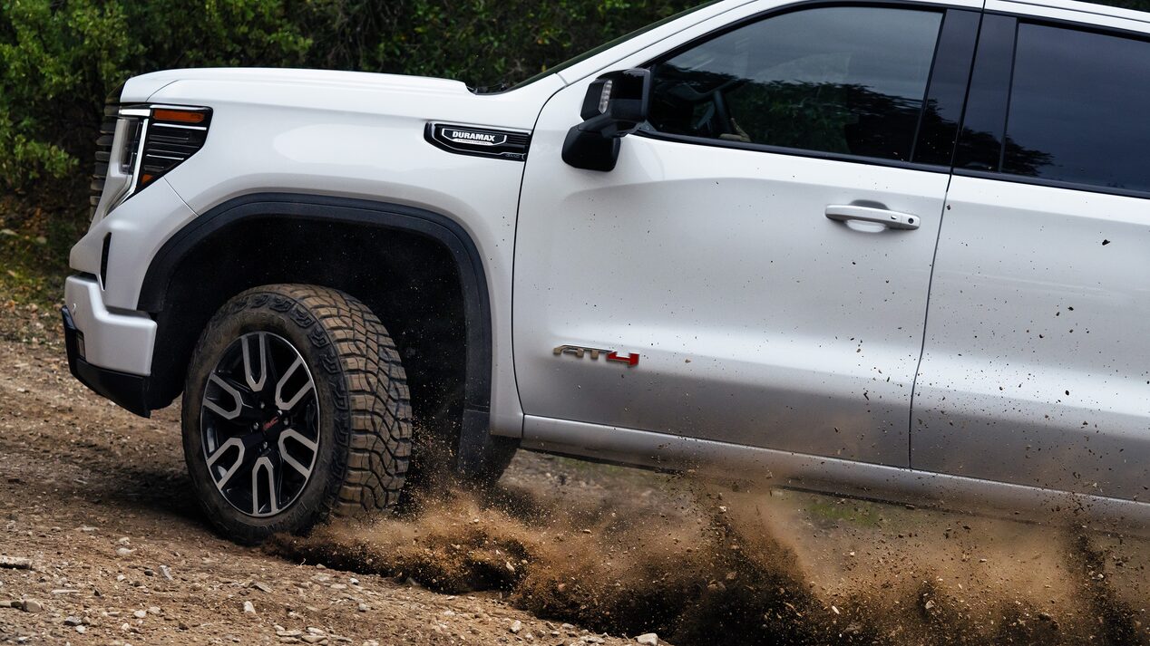 2026 GMC Sierra AT4 Diesel driving on dirt mountain side
