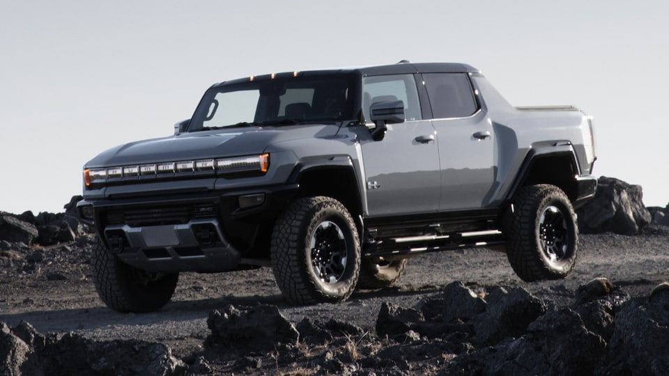 Front Three-Quarters View of a 2025 Hummer EV Pickup Truck Parked the Rocky Mountains
