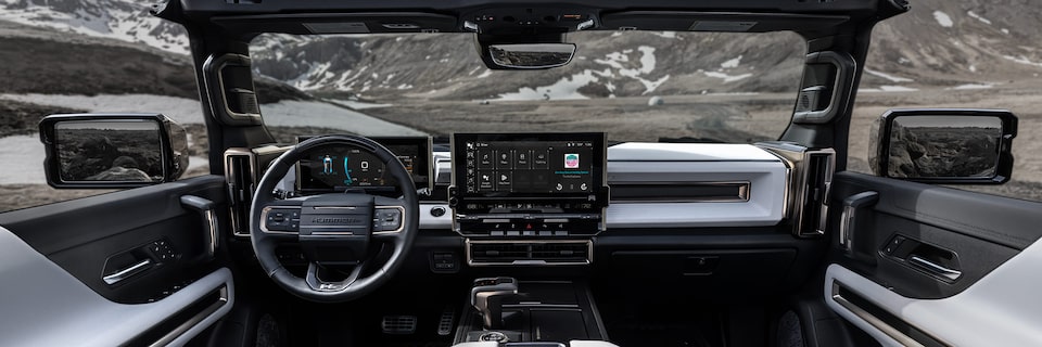 Back Seat View of the 2025 Hummer EV Sleek Dashboard and Advanced Infotainment System Overlooking the Mountains