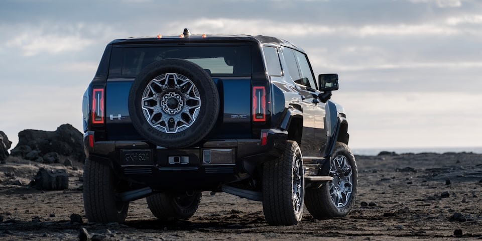 Rear View of a Black GMC Hummer EV SUV under an Evening Sky
