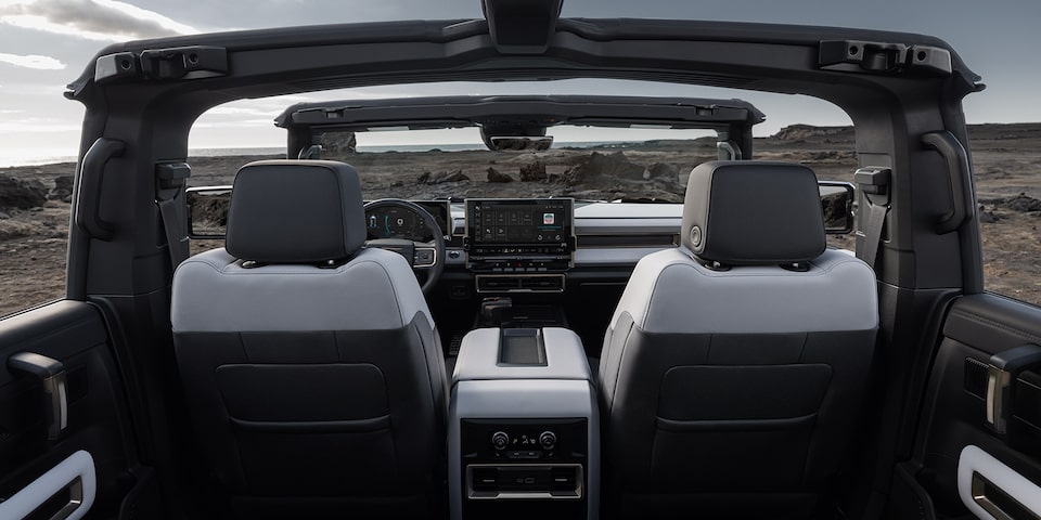 Passenger Seat View of a GMC Hummer EV SUV on a Rocky Plain