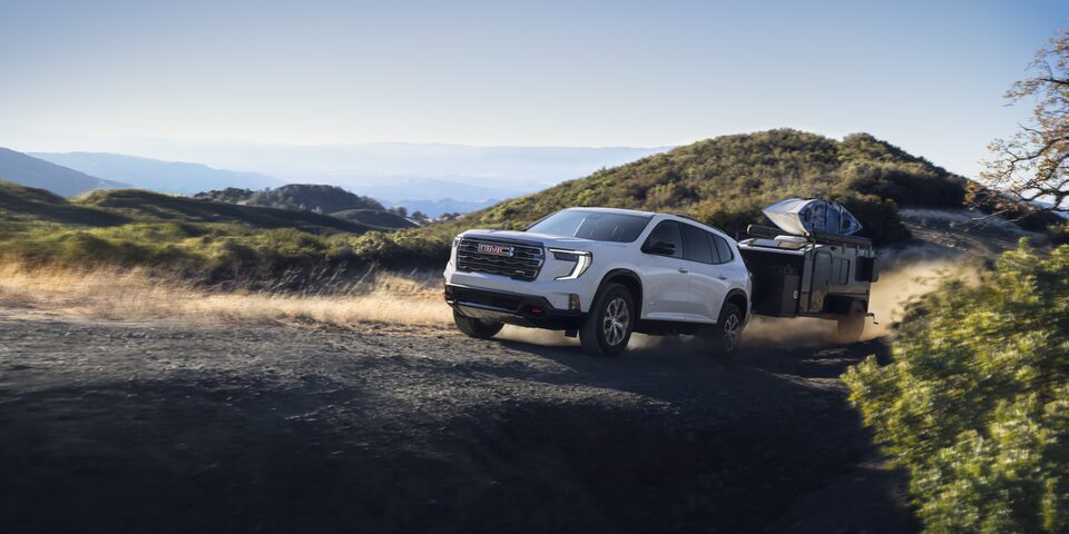 The GMC Acadia AT4 Mid-Size Off-Road SUV Towing a Trailer Off-Road