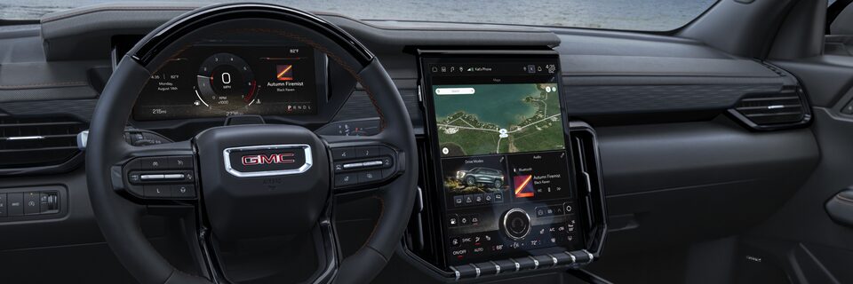 Drivers Side Interior View of the Steering Wheel and Infotainment System in the GMC Acadia AT4