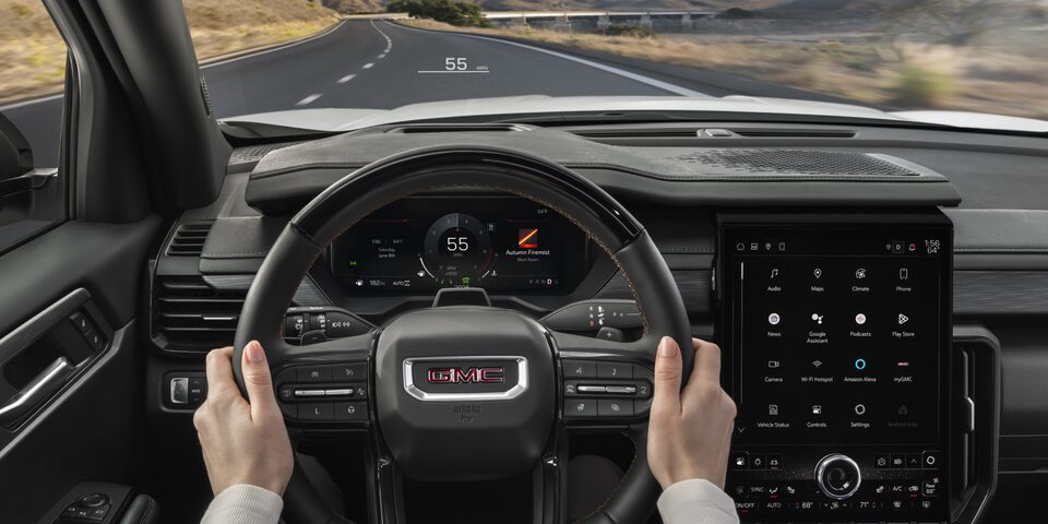 View of the Drivers Hands on the Steering Wheel in the GMC Acadia SUV