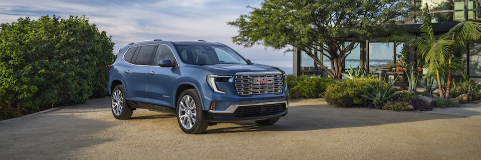 The GMC Acadia Luxury Mid-Size SUV Parked in the Driveway of a Beautiful Home