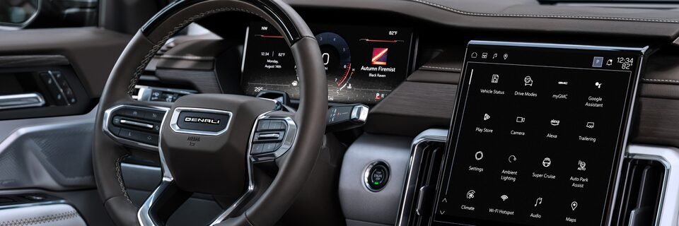 Passenger Side Interior View of the Steering Wheel and Infotainment System in the GMC Acadia
