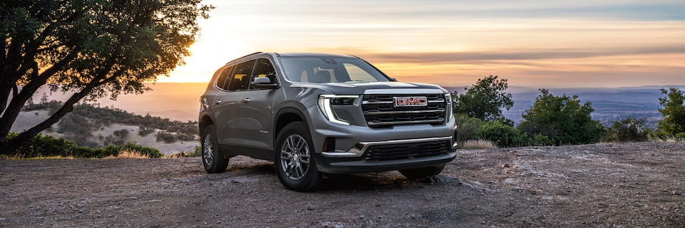 The 2025 GMC Acadia Parked Near the Water at Sunset