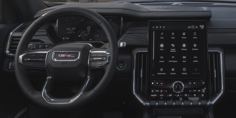 Interior View of the GMC Acadia Steering Wheel, Infotainment System, and Dashboard