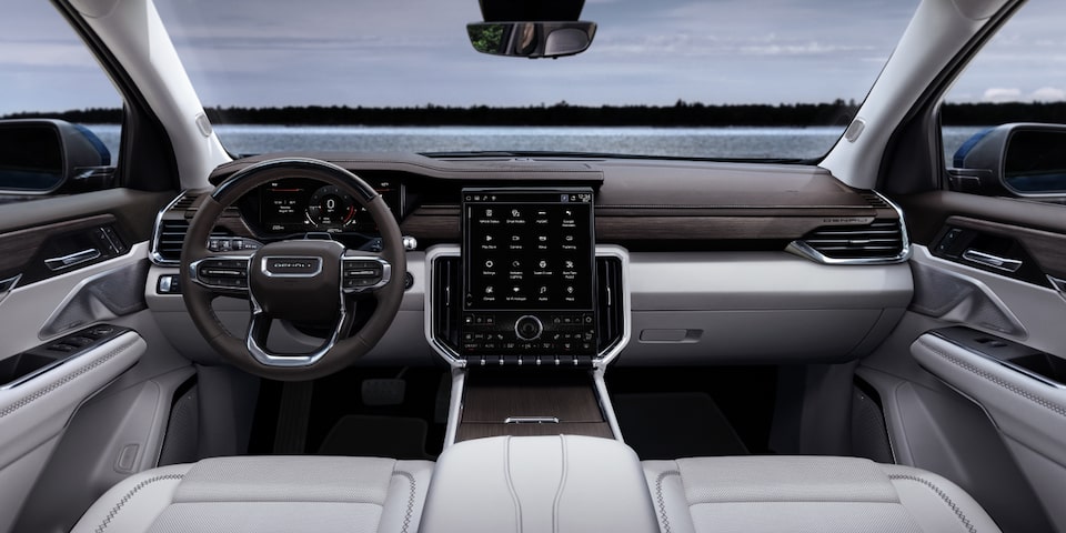 Interior View of the GMC Acadia Steering Wheel, Infotainment System, and Dashboard