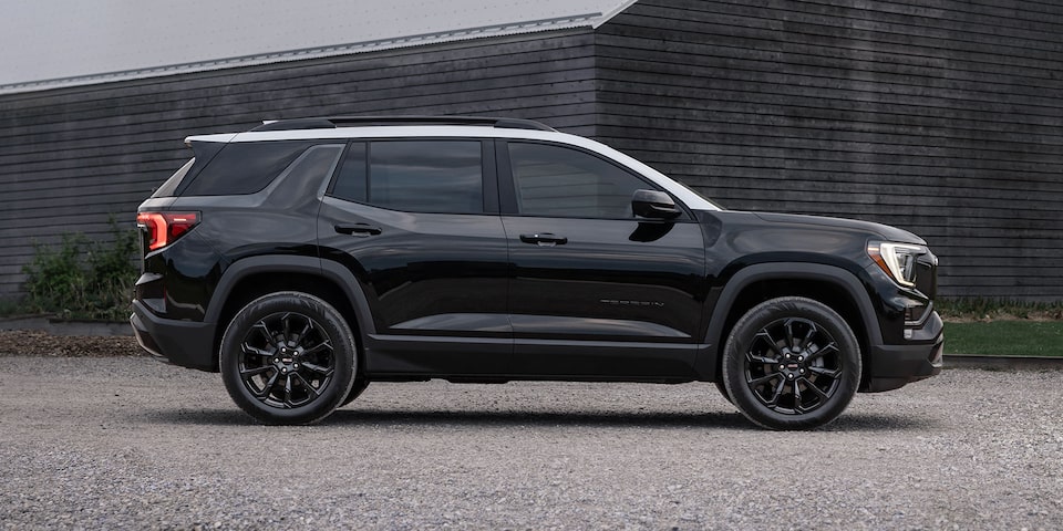 Profile View of the GMC Terrain Small SUV Parked in Front of a Building