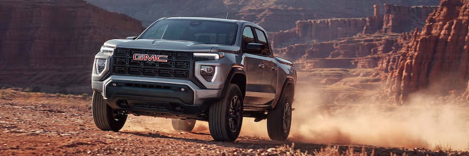 The 2025 GMC Canyon Truck Driving Through the Desert Kicking Up Dirt