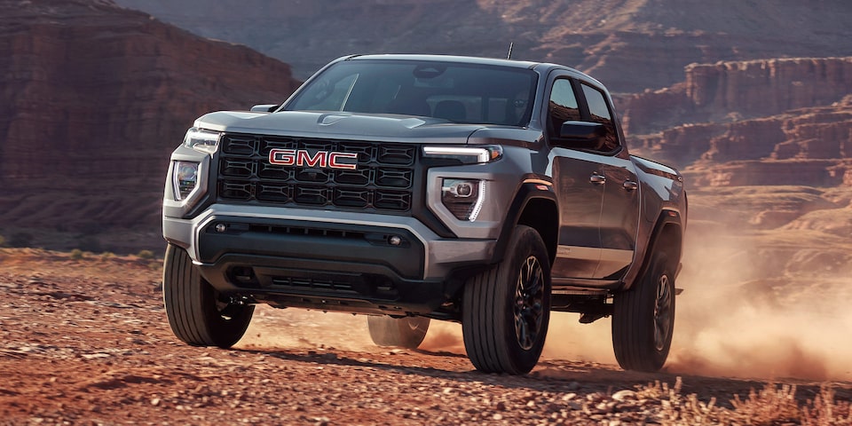 The 2025 GMC Canyon Truck Driving Through the Desert Kicking Up Dirt