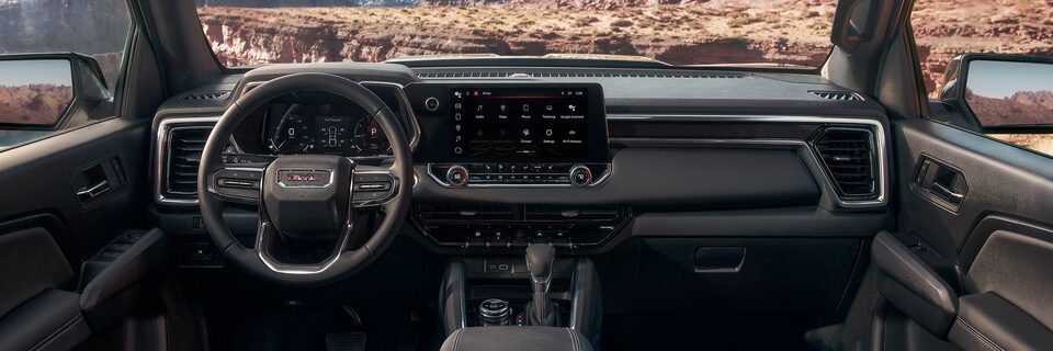 The 2025 GMC Canyon Elevation Front Interior with Steering Wheel and Infotainment System