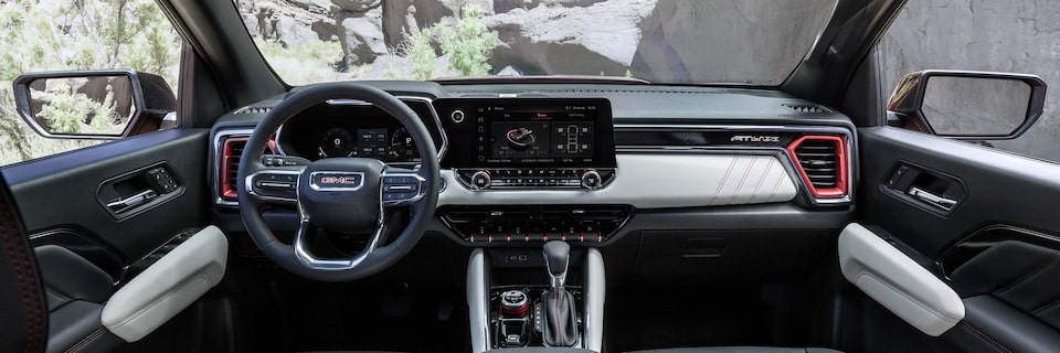 The 2025 GMC Canyon AT4 Front Interior with Steering Wheel and Infotainment System